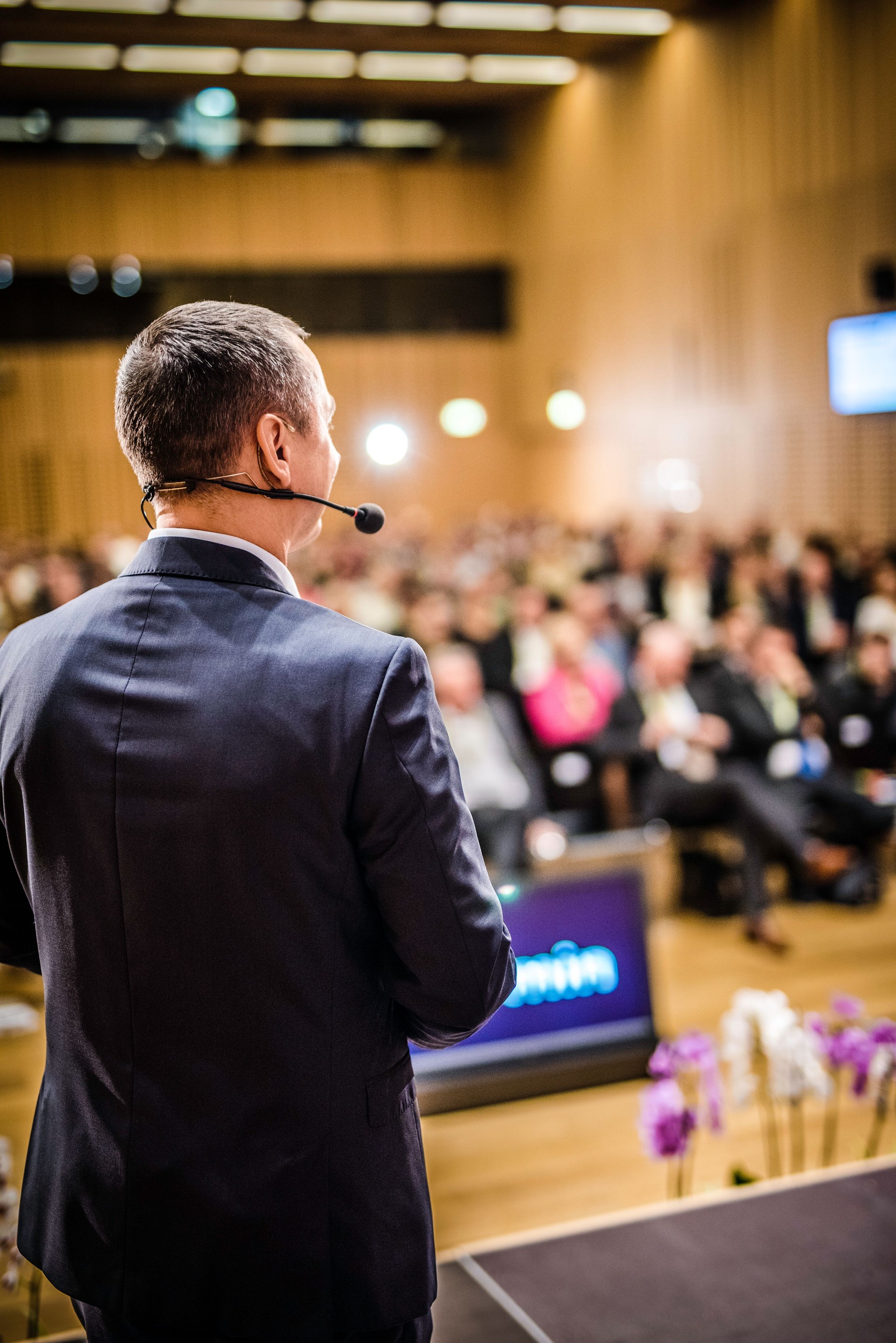 Rear view of a motivational coach giving a speech