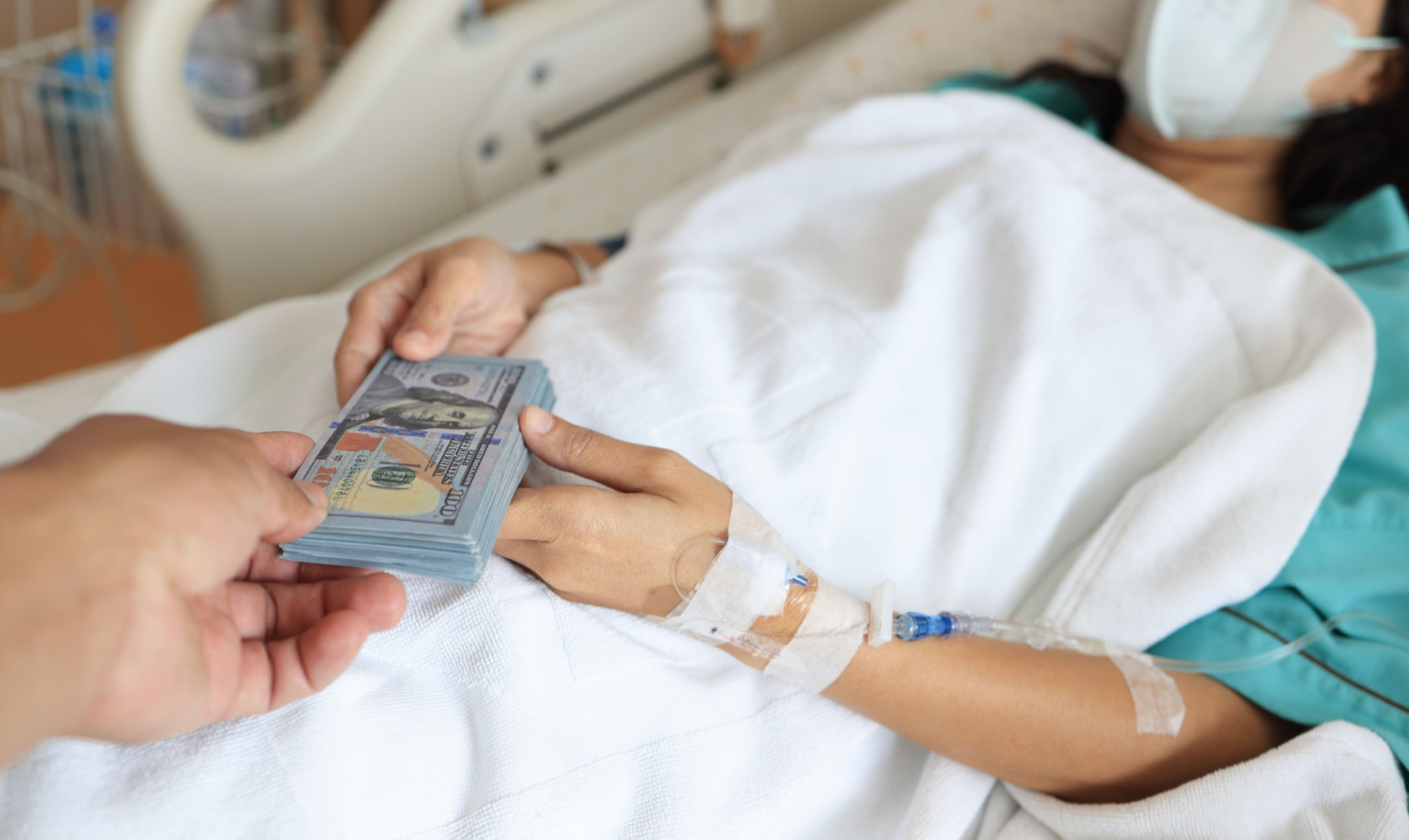 patient injury woman on a Patient's bed in a hospital received US  dollars from getting insurance money From insurance companies