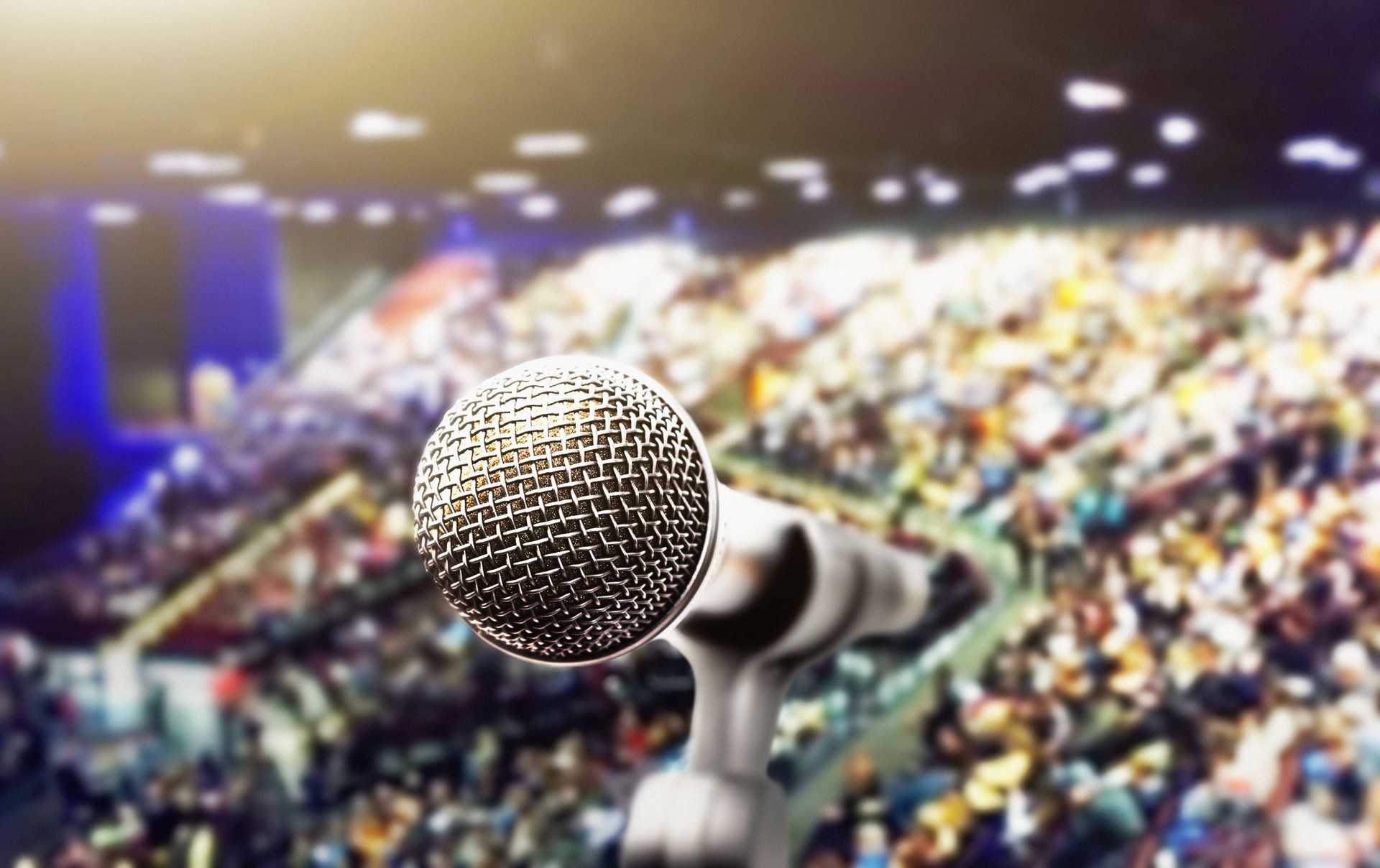 Microphone in front of a crowd of many people